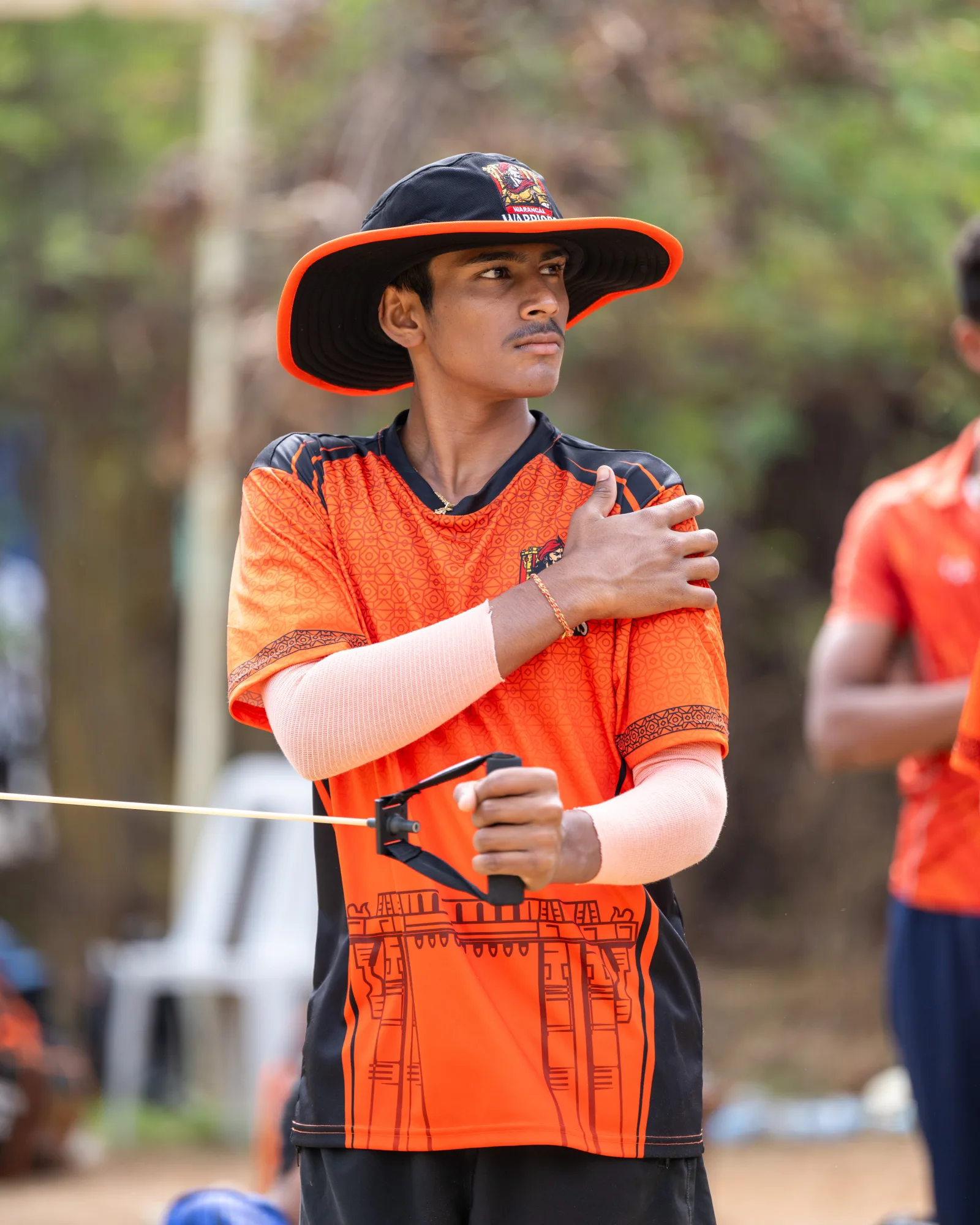 Player portrait in orange custom cricket jersey