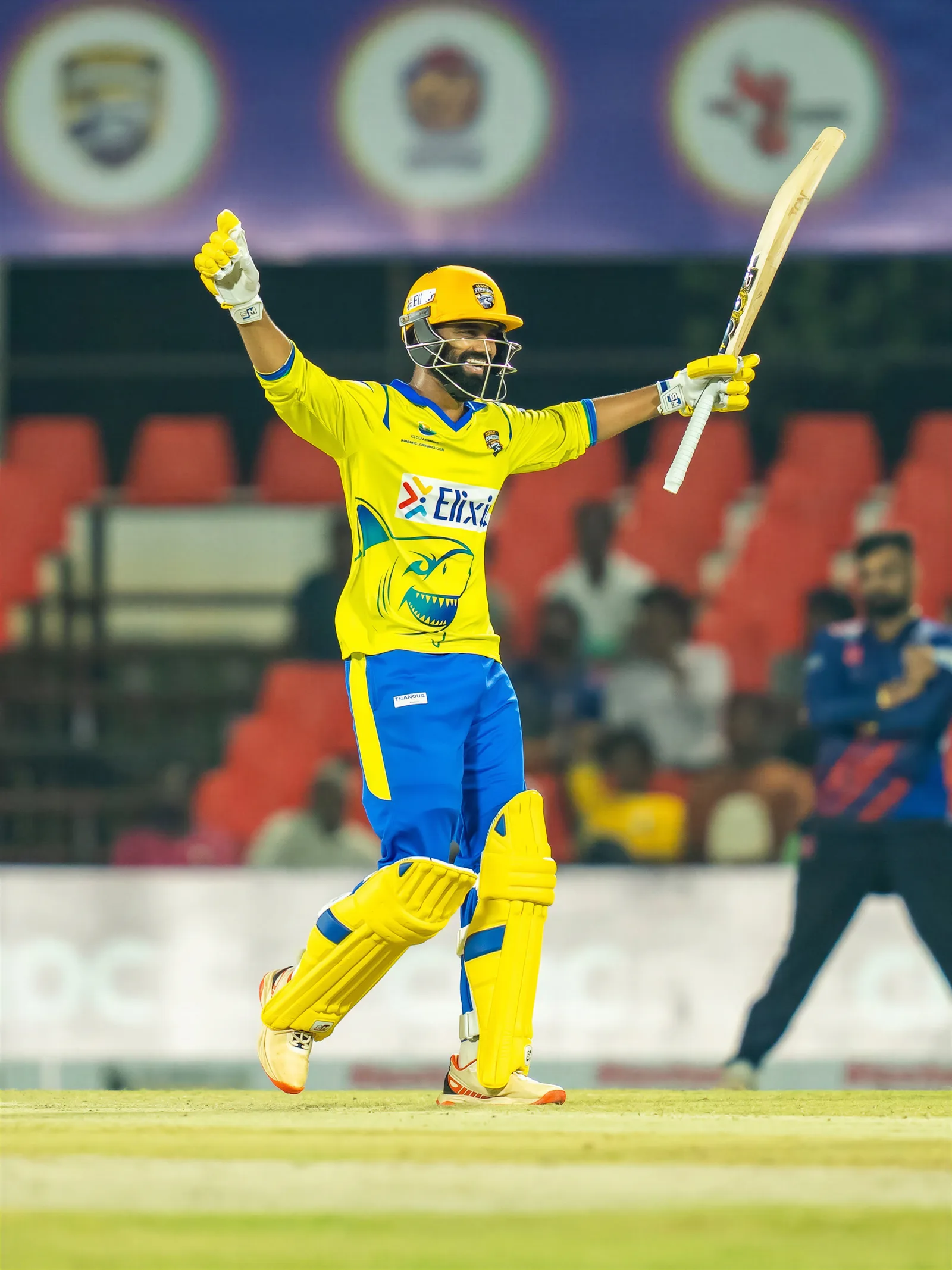 Cricket batter in yellow and blue custom cricket kit